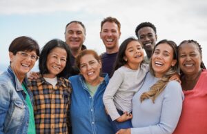 Group,Of,Multigenerational,People,Hugging,Each,Other,While,Smiling,On